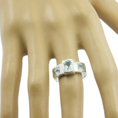 Ellie blue trilogy ring for women silver band with oval center blue gemstones and baguette side stones on display hand