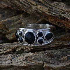 Isla boho black gemstone ring with multiple black stones set in silver band on rustic wood