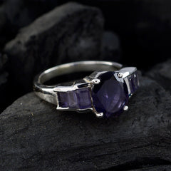 Hanna boho blue gemstone ring with faceted oval center stone and baguette side stones on silver band