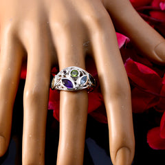 Isabel boho multicolor gemstone ring with green, purple, and blue stones on finger