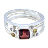 Boho multicolor gemstone ring by María featuring a square red center stone with smaller round stones on a silver band