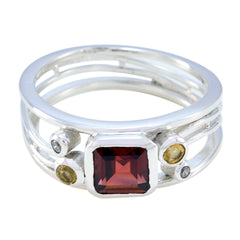 Boho multicolor gemstone ring by María featuring a square red center stone with smaller round stones on a silver band