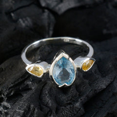 Katharina boho multicolor trilogy ring silver band pear blue center with two yellow side stones on black background