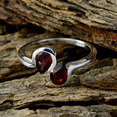 Hina boho red gemstone ring featuring two deep red stones set in polished silver band on rustic wood