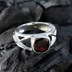 Cecilia silver boho red solitaire ring with deep red gemstone on textured dark background