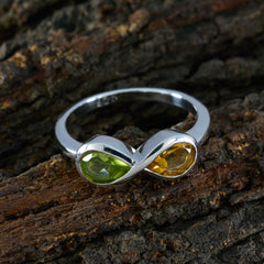 Yasmin silver ring featuring green and yellow stones in infinity design boho toi et moi ring