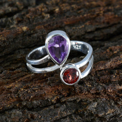 Dayana boho toi et moi ring with two gemstones in silver setting on rustic wood background