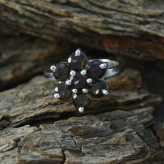Nella brown gemstone floral ring with faceted brown stones in a silver floral cluster on rustic bark
