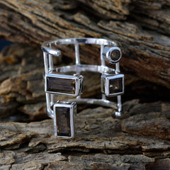 Fernanda brown gemstone signet ring with multiple rectangular stones set in silver band on rustic wood
