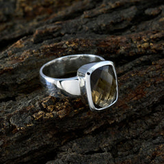 Lily sterling silver brown solitaire ring with faceted cushion gemstone bezel set on textured bark background for elegant wear