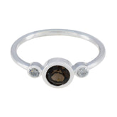 Wen brown trilogy gemstone ring with a central brown gemstone flanked by two clear stones on a silver band