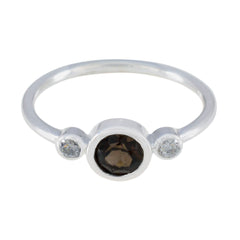Wen brown trilogy gemstone ring with a central brown gemstone flanked by two clear stones on a silver band