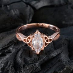 Claire rose gold Claddagh solitaire ring with marquise cut clear gemstone on dark textured background