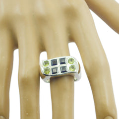 Sarah colorful statement ring silver featuring a wide silver band with square blue stones and round green gems