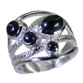 Pilar contemporary black gemstone ring with multiple round black stones set in textured silver band
