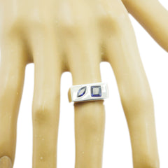 Tereza contemporary blue gemstone ring with two blue stones on silver band worn on finger