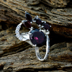 Sophia contemporary red gemstone ring with multiple red stones and silver band on wood background