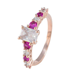 Teresa contemporary red gemstone ring rose gold band with rectangular clear center stone and round red accent stones