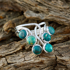 Lara contemporary turquoise ring with multiple turquoise stones set in silver on rustic wood