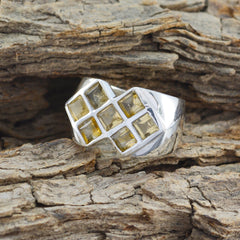 Mariana contemporary yellow gemstone ring with square-cut stones set in silver band on rustic wood