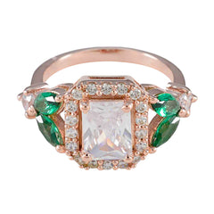 Eva emerald halo ring for women featuring a central rectangular stone surrounded by green emeralds and diamonds