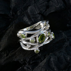 Nisa fairytale brown gemstone ring shown as silver multi band ring set with green peridot gemstones