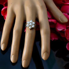 Kristine floral pearl statement ring on mannequin hand with vintage cluster pearls and silver band