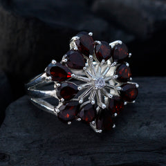 Nisa floral red gemstone ring with silver band featuring teardrop-shaped red stones in a flower design