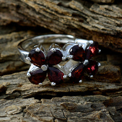 Natcha floral red gemstone ring with deep red stones arranged in a flower design on silver band
