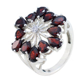 Nisa floral red gemstone ring with teardrop shaped red stones arranged in flower design on silver band
