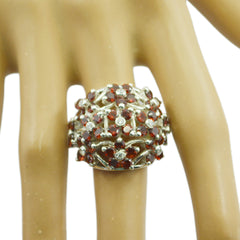 Fernanda floral red gemstone ring silver dome style with clear crystal accents on display hand