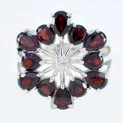 Nisa floral red gemstone ring with teardrop red gemstones arranged in a flower pattern on silver band
