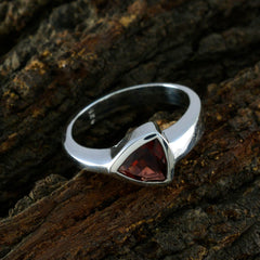 Riya geometric red solitaire ring with triangular red gemstone set in silver band on wood