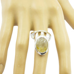 Meera golden solitaire ring for women with a large oval gemstone set on silver band