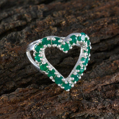 Luna green gemstone heart ring with silver band on textured brown bark background