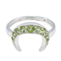Rina green gemstone ring featuring multiple round green stones set in a silver crescent design
