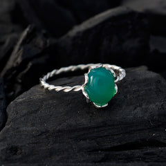 Xiu green gemstone solitaire ring with twisted silver band on dark textured background