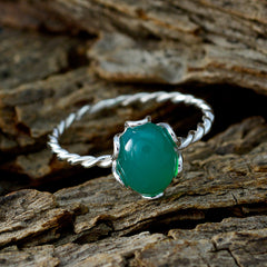 Xiu green gemstone solitaire ring with twisted silver band on rustic wooden background