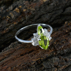 Ha-eun green gemstone toi et moi ring with two marquise-cut green stones and small clear accents on silver band