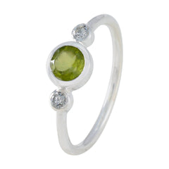 Lakshmi silver green gemstone trilogy ring with bezel set green center stone and two small clear side stones