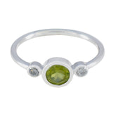 Lakshmi green gemstone trilogy ring silver band bezel set round peridot center with two small white side stones