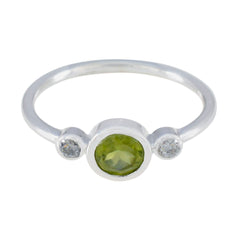 Lakshmi green gemstone trilogy ring silver band bezel set round peridot center with two small white side stones