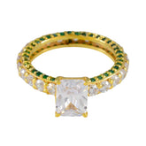 Teresa gold ring featuring a green halo engagement ring design with rectangular clear center stone
