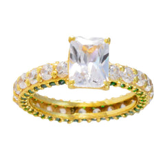 Teresa gold ring with large clear center stone and green halo engagement ring accents