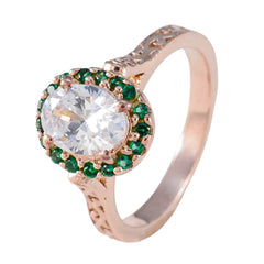 Putri green halo gemstone ring with an oval clear center stone surrounded by small green gemstones