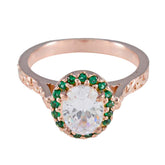 Putri green halo gemstone ring with rose gold band and large clear center stone surrounded by small green gemstones