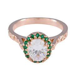 Putri green halo gemstone ring with rose gold band and large clear center stone surrounded by small green gemstones