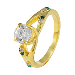 Meera gold ring with clear center stone and small emerald accents green halo ring for women