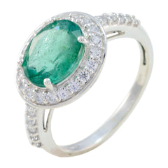 Dewi green halo ring with oval emerald center and diamond halo on white gold band