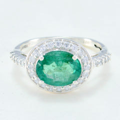 Dewi green halo ring with oval emerald center surrounded by diamond halo and pave white gold band